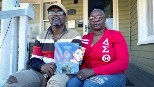  Oneida Oliver-Sanders (Right) and Shawn Sanders hold a photograph of their daughter, Spc. Kennedy Ladon Sanders at their Waycross GA home Tuesday, January. 30, 2024. (Joe Kovac/ Joe.Kovac@ajc.com)