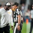 Pittsburgh Steelers head coach Mike Tomlin, left, talks to line judge Tim Podraza (47) during the first half of an NFL football game against the Dallas Cowboys, Sunday, Oct. 6, 2024, in Pittsburgh. (AP Photo/Gene J. Puskar)