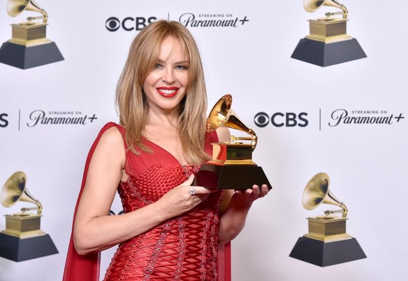 Kylie Minogue poses in the press room with the award for best pop dance recording for "Padam Padam" during the 66th annual Grammy Awards on Sunday, Feb. 4, 2024, in Los Angeles. (Photo by Richard Shotwell/Invision/AP)