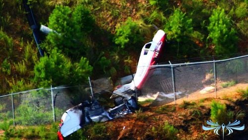 A small plane is on its side at the edge of a runway in Cherokee County. (Credit: Brett Barnhill)