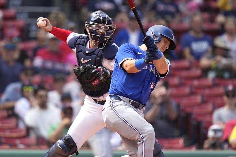 Boston Red Sox catcher Danny Jansen, left, tries to throw out a runner on a steal attempt as Toronto Blue Jays Daulton Varsho, who pinch-hit for Jansen, strikes out during the resumption of the second inning of a baseball game which was delayed due to rain in June, against the Toronto Blue Jays at Fenway Park, Monday, Aug. 26, 2024, in Boston. (AP Photo/Charles Krupa)