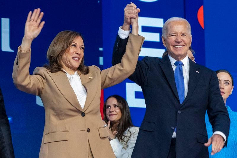 Democratic presidential nominee Vice President Kamala Harris, left, clasps her hand in the air with President Joe Biden at the Democratic National Convention, Monday, Aug. 19, 2024, in Chicago. (AP Photo/Jacquelyn Martin)