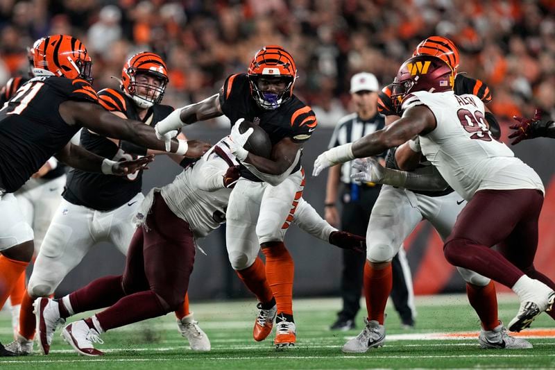 Cincinnati Bengals running back Zack Moss (31) carries the ball up field during the second half of an NFL football game against the Washington Commanders, Monday, Sept. 23, 2024, in Cincinnati. (AP Photo/Carolyn Kaster)