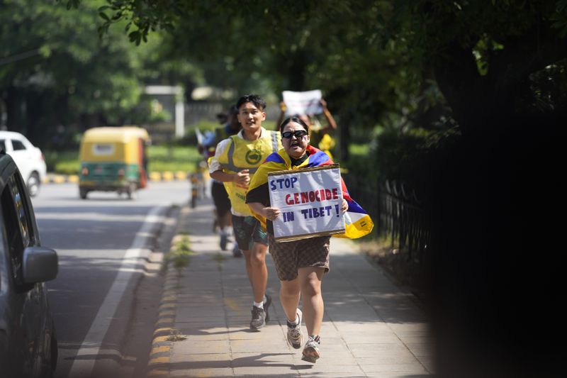 Exile Tibetans shout slogans against the human rights situation in Tibet during a protest to coincide China marking its 75th year of Communist Party rule, outside Chinese embassy, in New Delhi, India, Tuesday, Oct. 1, 2024. (AP Photo/Manish Swarup)