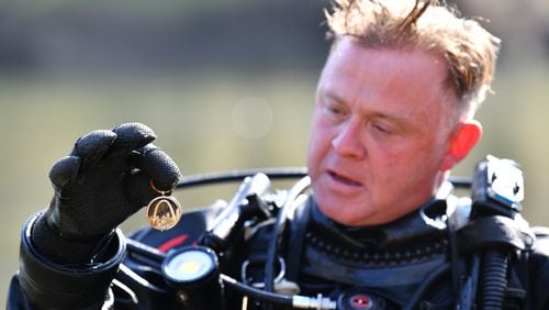 Jeremy Sides holds a necklace that he found while diving in the Chattahoochee River for his YouTube channel, Exploring with Nug, Sides began his adventuring career as a treasure hunt, but recently began solving cold cases, finding the sunken vehicles of individuals missing for years. (Hyosub Shin / Hyosub.Shin@ajc.com)