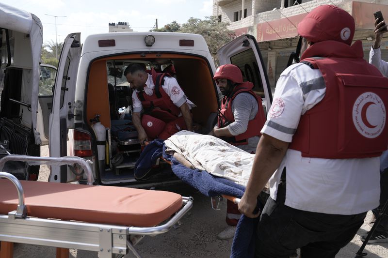 Paramedics carry the body of Ayed Abu Al-Hija, 64, a Palestinian who died during a military operation in the West Bank refugee camp of Nur Shams, Tulkarem, Thursday, Aug. 29, 2024. (AP Photo/Majdi Mohammed)