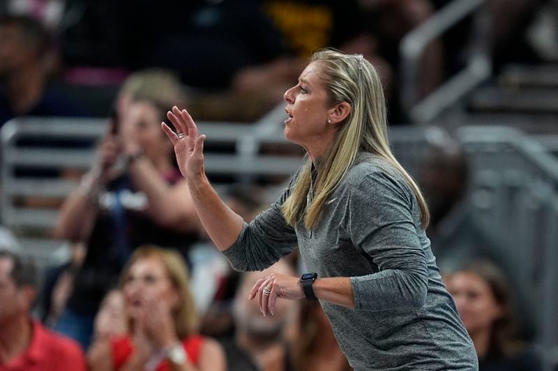 Indiana Fever head coach Christie Sides talks to players from the sidelines during the second half of a WNBA basketball game against the Phoenix Mercury, Friday, Aug. 16, 2024, in Indianapolis. (AP Photo/Darron Cummings)