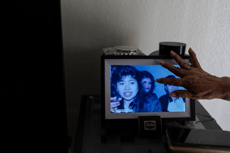 Marina Maalouf, a longtime resident of Hillside Villa who participated in protests after rents doubled in 2019, scrolls through a digital album in her apartment in Los Angeles, Tuesday, Oct. 1, 2024. (AP Photo/Jae C. Hong)