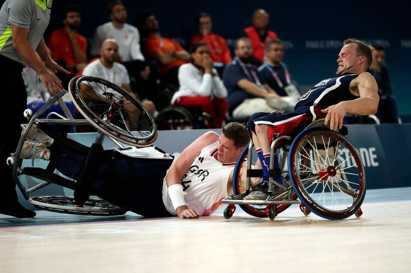 Britain's Lee Manning falls down next to John Boie of the U.S., during the wheelchair basketball men's gold medal match at the 2024 Paralympics, Saturday, Sept. 7, 2024, in Paris, France. (AP Photo/Thomas Padilla)