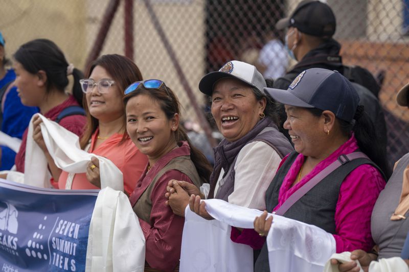 Friends and family members celebrate as renowned Sherpa mountain guide Kami Rita, returning from Mount Everest after his record 30th successful ascent, arrives at the airport in Kathmandu, Nepal, Friday, May 24, 2024. (AP Photo/Niranjan Shrestha)