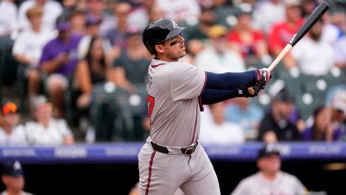 Atlanta Braves' Austin Riley follows the flight of his solo home run off Colorado Rockies starting pitcher Kyle Freeland in the first inning of a baseball game Sunday, Aug. 11, 2024, in Denver. (AP Photo/David Zalubowski)