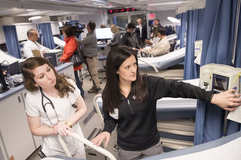 In this file photo, nurse Kristy Haynes (right) shows resident nurse Brittany Evans around Carolinas MED-1, a mobile medical facility located outside of the Marcus trauma and emergency room at Grady Memorial Hospital. ALYSSA POINTER / ALYSSA.POINTER@AJC.COM