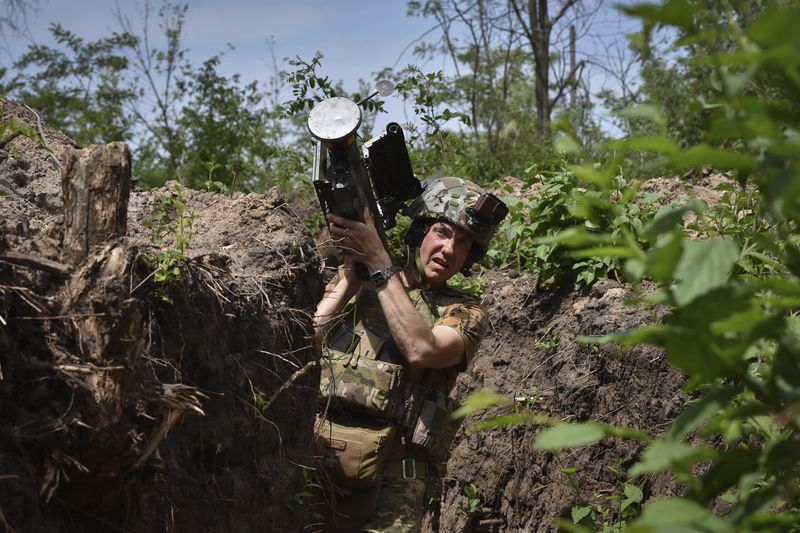 FILE - A Ukrainian serviceman carries a U.S. Stinger air-defense missile launcher on the front line in the Zaporizhzhia region of Ukraine, on Tuesday, May 28, 2024. Russian troops are forging through Ukraine's defenses along the front line in a relentless onslaught this summer, prompting the West to push for new weapons and strategies to shore up Kyiv. (AP Photo/Andriy Andriyenko, File)