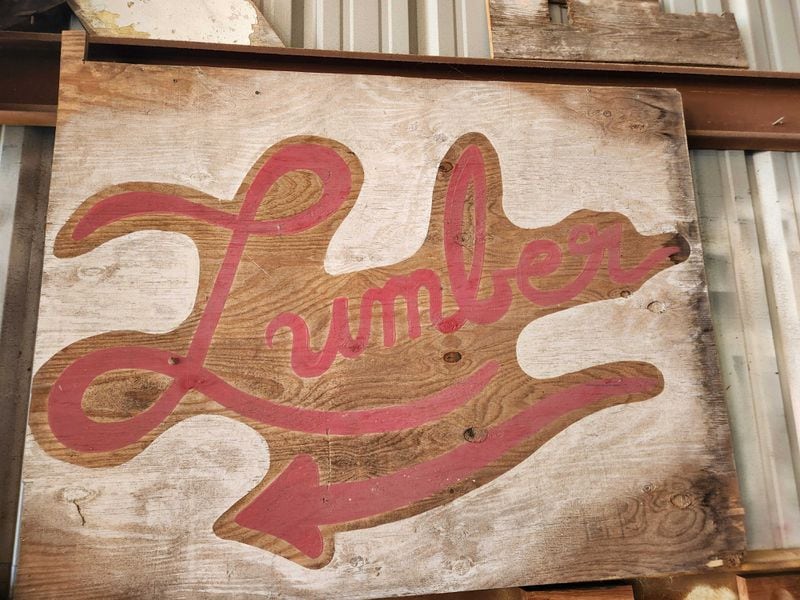 A sign advertises lumber at the Re:Purpose Savannah warehouse on the east side of Savannah. (Photo Courtesy of Emily Jones/WABE)