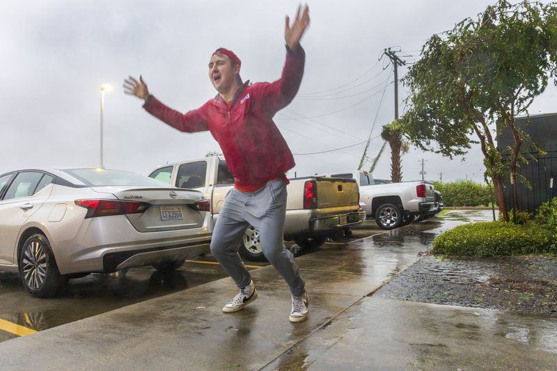 Having never before experienced the powerful forces of a hurricane, meteorologist Max Claypool of Memphis, Tenn. tries to see if the powerful winds blowing from the Hurricane Francine eye wall could lift him further in the air on Wednesday, Sept.11, 2024, Houma, La. (Chris Granger/The Times-Picayune/The New Orleans Advocate via AP)