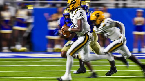 Valdosta quarterback Todd Robinson (2) looks for an opening as he’s pressured into running the ball in the second half of his game Friday, September 22, 2023. (Photo by Daniel Varnado/For the AJC)