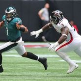 Falcons defensive lineman Grady Jarrett runs Philadelphia Eagles quarterback Jalen Hurts out of bounds on a 4th-and-4 attempt to turn it over on downs during the second quarter Sunday, Sept. 12, 2021, at Mercedes-Benz Stadium in Atlanta. (Curtis Compton / Curtis.Compton@ajc.com)