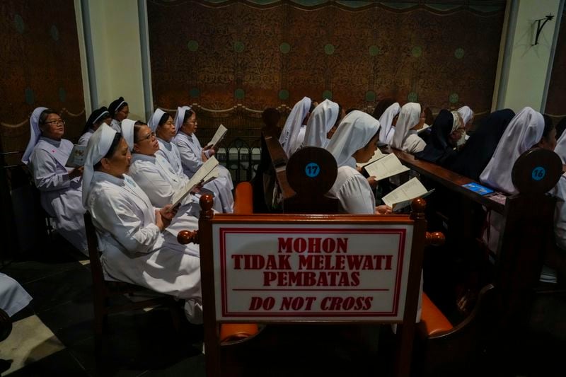 Nuns wait for the arrival of Pope Francis inside the Cathedral of Our Lady of the Assumption in Jakarta, Wednesday, Sept. 4, 2024. Francis had a packed first full day in Indonesia, meeting with outgoing President Joko Widodo and other Indonesian authorities at the presidential palace and then greeting Catholic priests, nuns and seminarians at Jakarta's main cathedral in the afternoon. (AP Photo/Gregorio Borgia)