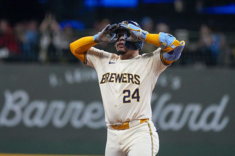 Milwaukee Brewers' William Contreras reacts after hitting a two-run scoring double during the third inning of a baseball game against the Philadelphia Phillies Monday, Sept. 16, 2024, in Milwaukee. (AP Photo/Morry Gash)