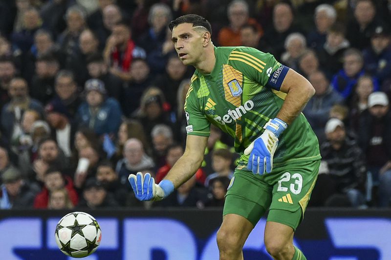 Aston Villa's goalkeeper Emiliano Martinez throws the ball during the Champions League opening phase soccer match between Aston Villa and Bayern Munich, at Villa Park in Birmingham, England, Wednesday, Oct. 2, 2024. (AP Photo/Rui Vieira)