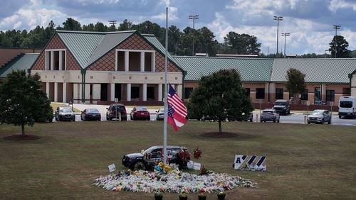 An aerial photo shows a makeshift memorial at Apalachee High School, Thursday, Sept. 19, 2024, in Winder. Students at Apalachee High School north of Atlanta will return to campus for half-days on Sept. 24, Barrow County school officials announced. (Hyosub Shin / AJC)