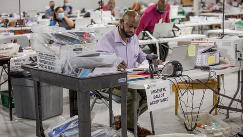 Gwinnett Voter Registations and Elections office is busy with poll workers delivering ballots and scanned data as well as counting absentee ballots and organize provisional ballots on Tuesday, Nov 3, 2020.  (Jenni Girtman for The Atlanta Journal-Constitution)