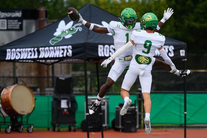 Ethan Ervin and Sam Harkness celebrate a Buford touchdown against host Roswell on September 6, 2024. Buford cruised 52-17. (Jamie Spaar for the Atlanta Journal Constitution)