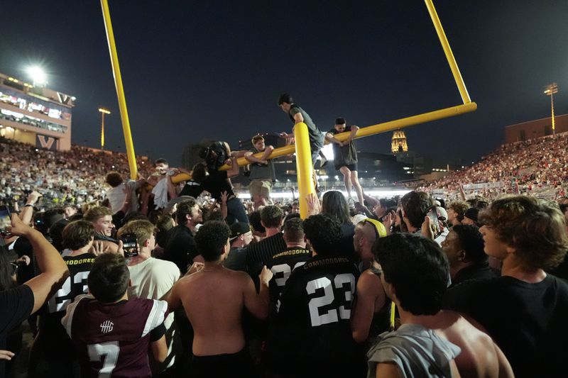 Vanderbilt fans tear down the goal post the after team's 40-35 win against Alabama in an NCAA college football game Saturday, Oct. 5, 2024, in Nashville, Tenn. (AP Photo/George Walker IV)