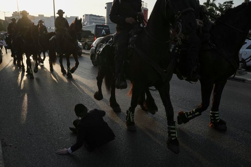 Israeli mounted police officers disperse Ultra-Orthodox Jews blocking a highway during a protest against army recruitment in Bnei Brak, Israel, Thursday, June 27, 2024. Israel's Supreme Court unanimously ordered the government to begin drafting ultra-Orthodox Jewish men into the army — a landmark ruling seeking to end a system that has allowed them to avoid enlistment into compulsory military service. (AP Photo/Oded Balilty)