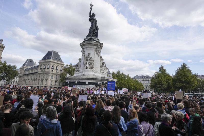 People take part in a gathering at Place de la Rebublique in support of 71-year-old Gisele Pelicot who was allegedly drugged by her ex-husband and raped by dozens of men while unconscious, Saturday, Sept. 14, 2024 in Paris. (AP Photo/Michel Euler)