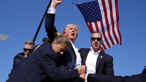 FILE - Republican presidential candidate former President Donald Trump is surrounded by U.S. Secret Service agents at a campaign rally, July 13, 2024, in Butler, Pa. (AP Photo/Evan Vucci, File)