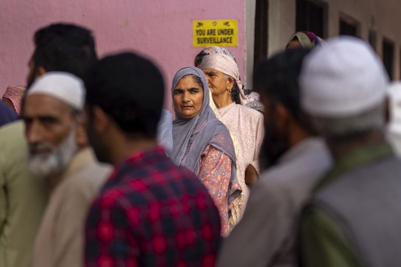 Kashmiri's queue up at a polling booth to cast their vote during the second phase of the assembly election in the outskirts of Srinagar, Indian controlled Kashmir, Wednesday, Sept. 25, 2024. (AP Photo/Dar Yasin)