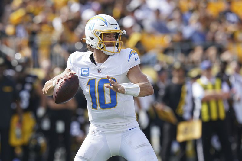 Los Angeles Chargers quarterback Justin Herbert looks for an open receiver during the first half of an NFL football game against the Pittsburgh Steelers, Sunday, Sept. 22, 2024, in Pittsburgh. (AP Photo/Matt Freed)