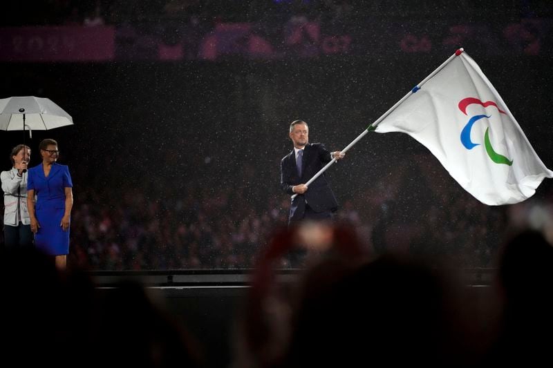 President of the International Paralympic Committee Andrew Parsons passes the Paralympic flag to Mayor of Los Angeles Karen Bass, second left, after receiving it from Mayor of Paris Anne Hidalgo, not pictured, during the closing ceremony of the 2024 Paralympics, Sunday, Sept. 8, 2024, in Paris, France. (AP Photo/Michel Euler)