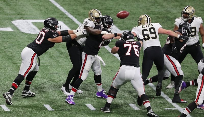 Saints defensive end Carl Granderson knocks the ball out for a turnover as he hammers Matt Ryan during the fourth quarter Sunday, Dec. 6, 2020, at Mercedes-Benz Stadium in Atlanta. (Curtis Compton / Curtis.Compton@ajc.com)