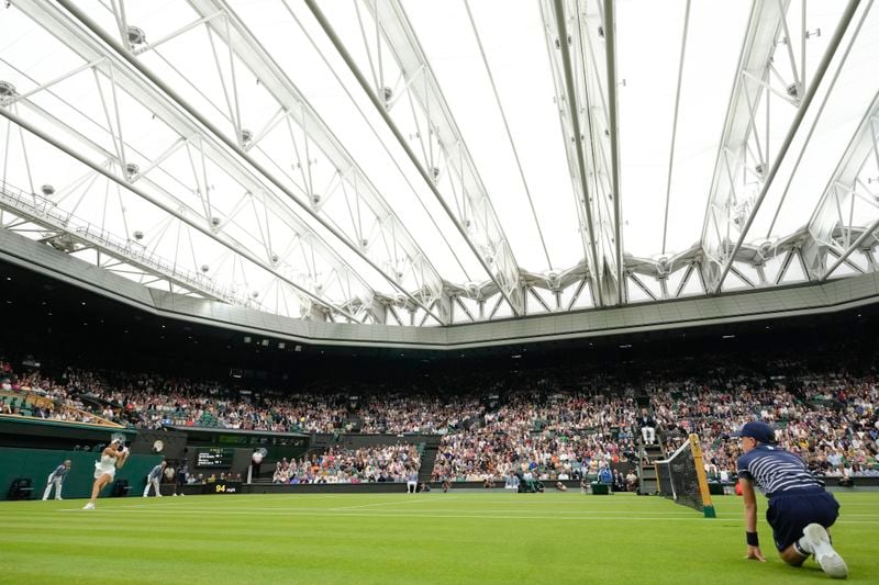 Marketa Vondrousova of the Czech Republic plays a backhand return to Jessica Bouzas Maneiro of Spain on Centre Court during their first round match at the Wimbledon tennis championships in London, Tuesday, July 2, 2024. (AP Photo/Kirsty Wigglesworth)