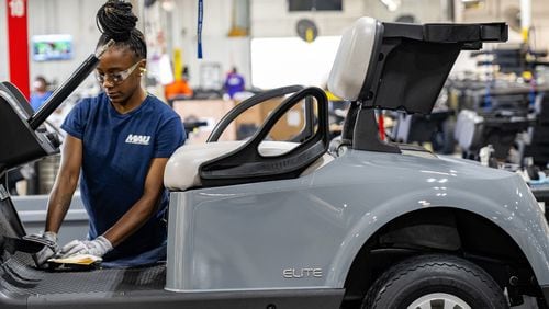 Worker at Textron Specialized Vehicles making a golf cart on assembly line in Augusta.