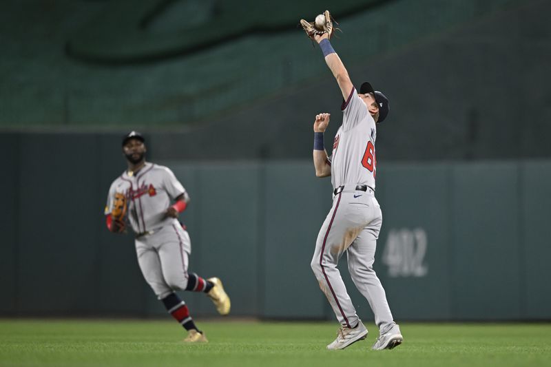 Atlanta Braves center fielder Michael Harris II, left, watches Braves second baseman Luke Williams catch a pop up fly ball by Washington Nationals' Keibert Ruiz for the second out of the sixth inning of a baseball game, Tuesday, Sept. 10, 2024, in Washington. (AP Photo/John McDonnell)