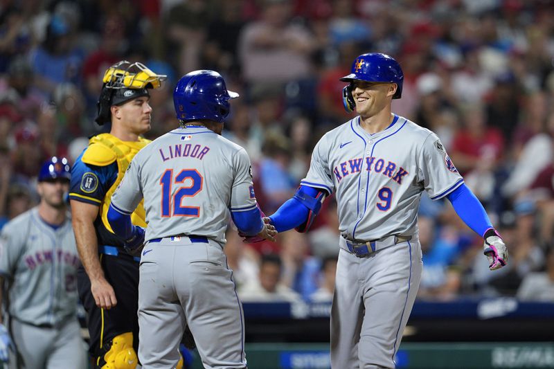 New York Mets' Brandon Nimmo (9) celebrates his three run home run off Philadelphia Phillies' Aaron Nola with Mets' Francisco Lindor (12) during the fifth inning of a baseball game, Friday, Sept. 13, 2024, in Philadelphia. (AP Photo/Derik Hamilton)