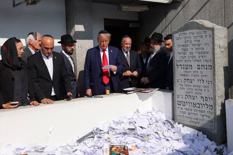 Republican presidential nominee former President Donald Trump, center, visits the gravesite of Rabbi Menachem Mendel Schneerson at Ohel Chabad-Lubavitch, Monday, Oct. 7, 2024, in New York. (AP Photo/Yuki Iwamura)