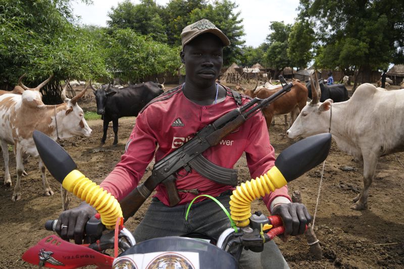 Charo Ochogi poses for a photo in Otallo village, South Sudan, Wednesday, June 19, 2024. Ochogi said he's not worried about the animals disappearing. (AP Photo/Brian Inganga)