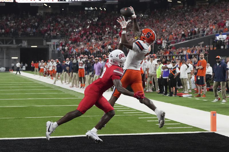 Syracuse wide receiver Jackson Meeks scores a touch down over UNLV defensive back Tony Grimes (0) in the second half during an NCAA college football game, Friday, Oct. 4, 2024, in Las Vegas. (AP Photo/Rick Scuteri)