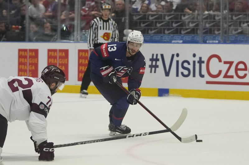 FILE - Unted States' Johnny Gaudreau, right, challenges for a puck with Latvia's Janis Jaks during the preliminary round match between Latvia and United States at the Ice Hockey World Championships in Ostrava, Czech Republic, Tuesday, May 21, 2024. (AP Photo/Darko Vojinovic, file)