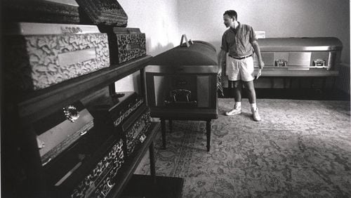 Tom Fox visiting the Spring Hill funeral home to make arrangements for his funeral. Although he has decided to be cremated, he is taking a moment to help his friend and fellow AIDS sufferer, Pat Heinrich, choose a casket, Atlanta, Georgia, August 29, 1988. Michael Schwarz / The Atlanta Journal-Constitution