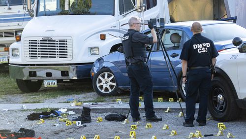 Crime scene investigators work at the scene where two Des Moines police officers were shot and the suspected shooter was killed by officers in an exchange of gunfire in Des Moines, Iowa, early Monday, Sept. 16, 2024. (Cody Scanlan/The Des Moines Register via AP)