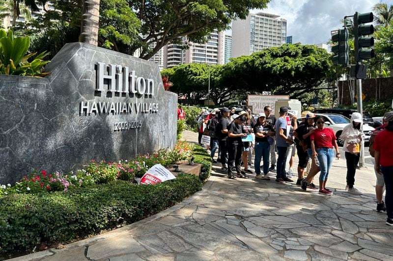 Hotel workers march outside the Hilton Hawaiian Village resort after going on strike on Tuesday, Sept. 24, 2024, in Honolulu. (AP Photo/Jennifer Sinco Kelleher)