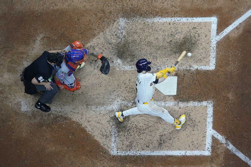 Milwaukee Brewers' Garrett Mitchell hits a two-run home run during the eighth inning of Game 2 of a National League wild card baseball game against the New York Mets Wednesday, Oct. 2, 2024, in Milwaukee. (AP Photo/Morry Gash)