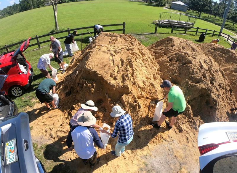 Residents fill sandbags at the Orange County distribution site at Barnett Park in Orlando, Fla., Tuesday, Sept. 24, 2024, ahead of the forecast for the possibility of heavy rains in Central Florida. (Joe Burbank/Orlando Sentinel via AP)