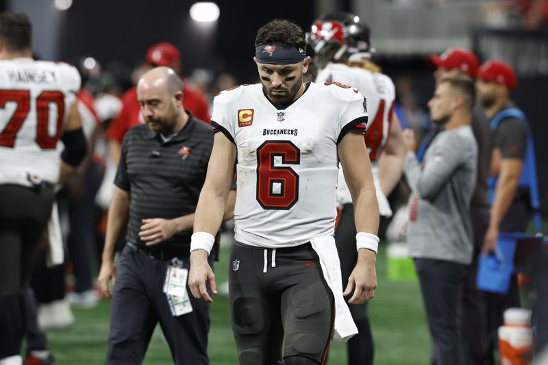 Tampa Bay Buccaneers quarterback Baker Mayfield walks off after the team lost to the Atlanta Falcons during overtime in an NFL football game Thursday, Oct. 3, 2024, in Atlanta. (AP Photo/Butch Dill)