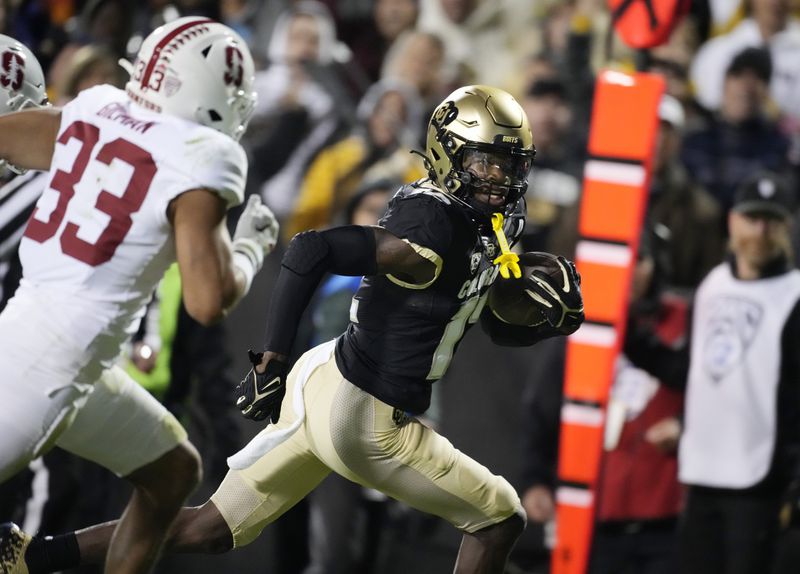 FILE - Colorado wide receiver Travis Hunter, right, runs past Stanford safety Alaka'i Gilman on the way to scoring a touchdown during the first half of an NCAA college football game Friday, Oct. 13, 2023, in Boulder, Colo. (AP Photo/David Zalubowski, File)